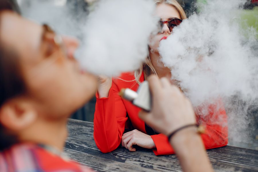 a man and a woman vaping